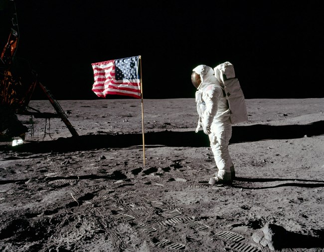 An American flag is observed by an astronaut