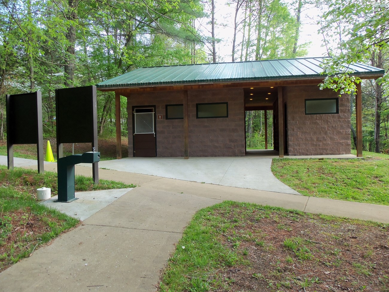 A small public building in a wooded area.