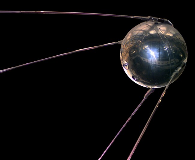 A metallic ball with strands protruding