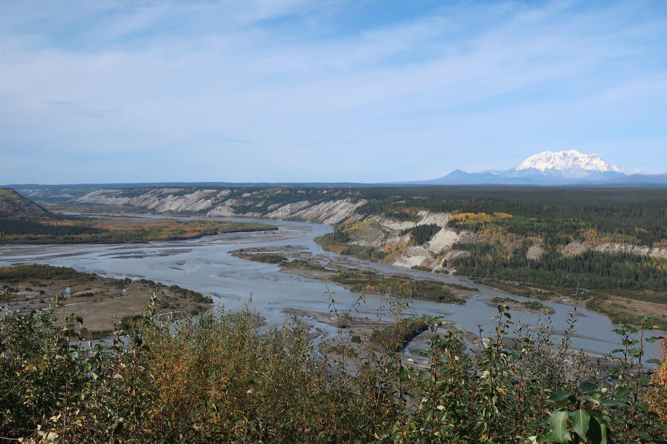 The wide Copper River winding through a valley, with a snow-covered mountain behind