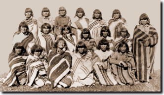 Hopi prisoners pose on Alcatraz Island wearing woven sarape