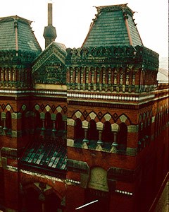 Red brick building with two wide towers intermixed with marble.