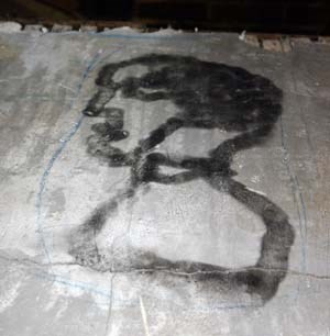 Photo of plaster with charred image.