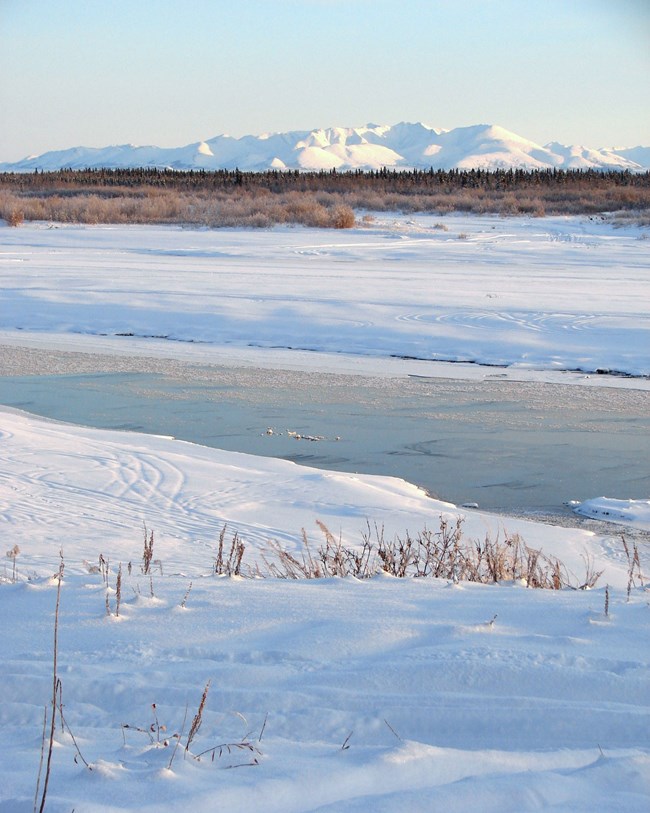 winter view of river and mountains beyond