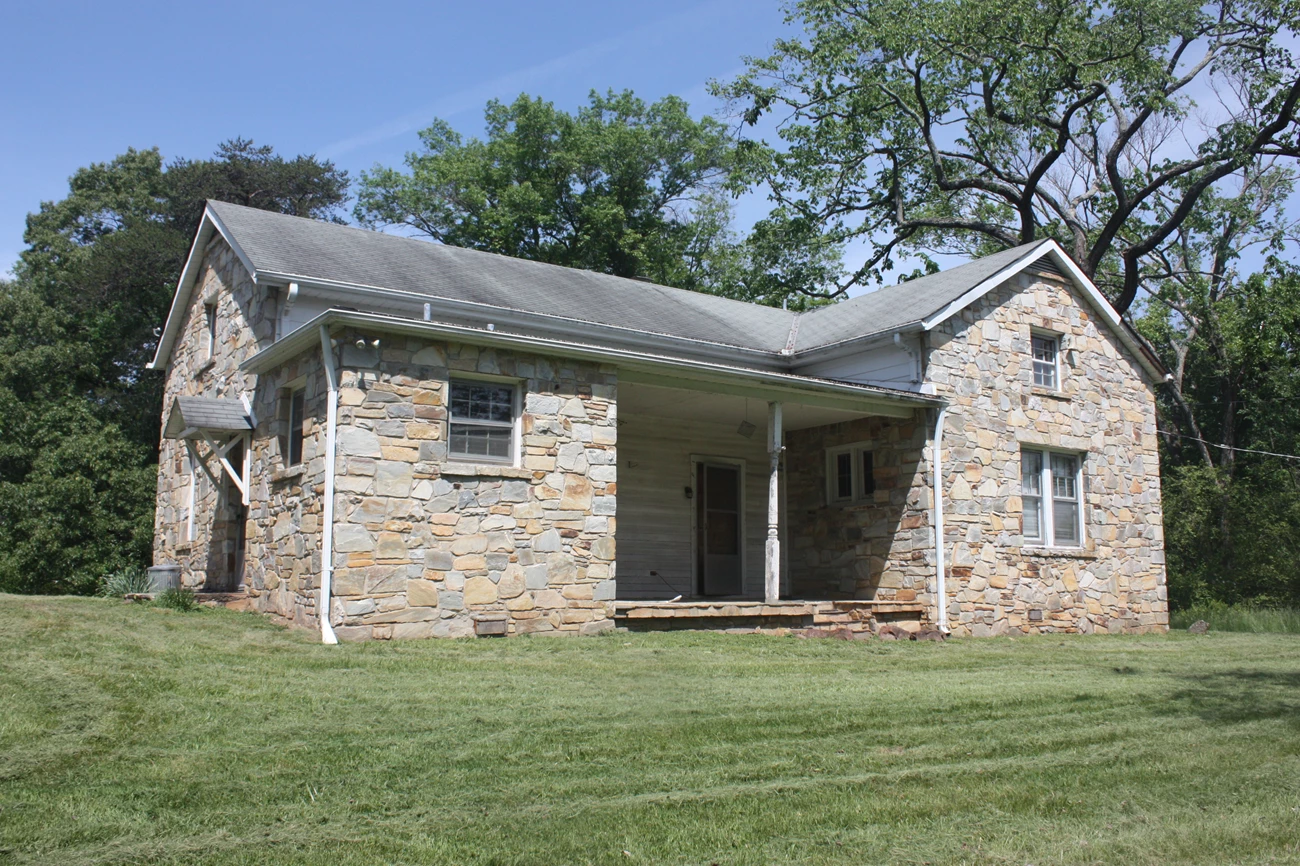 The Groveton School in 2023, a white two-room frame building