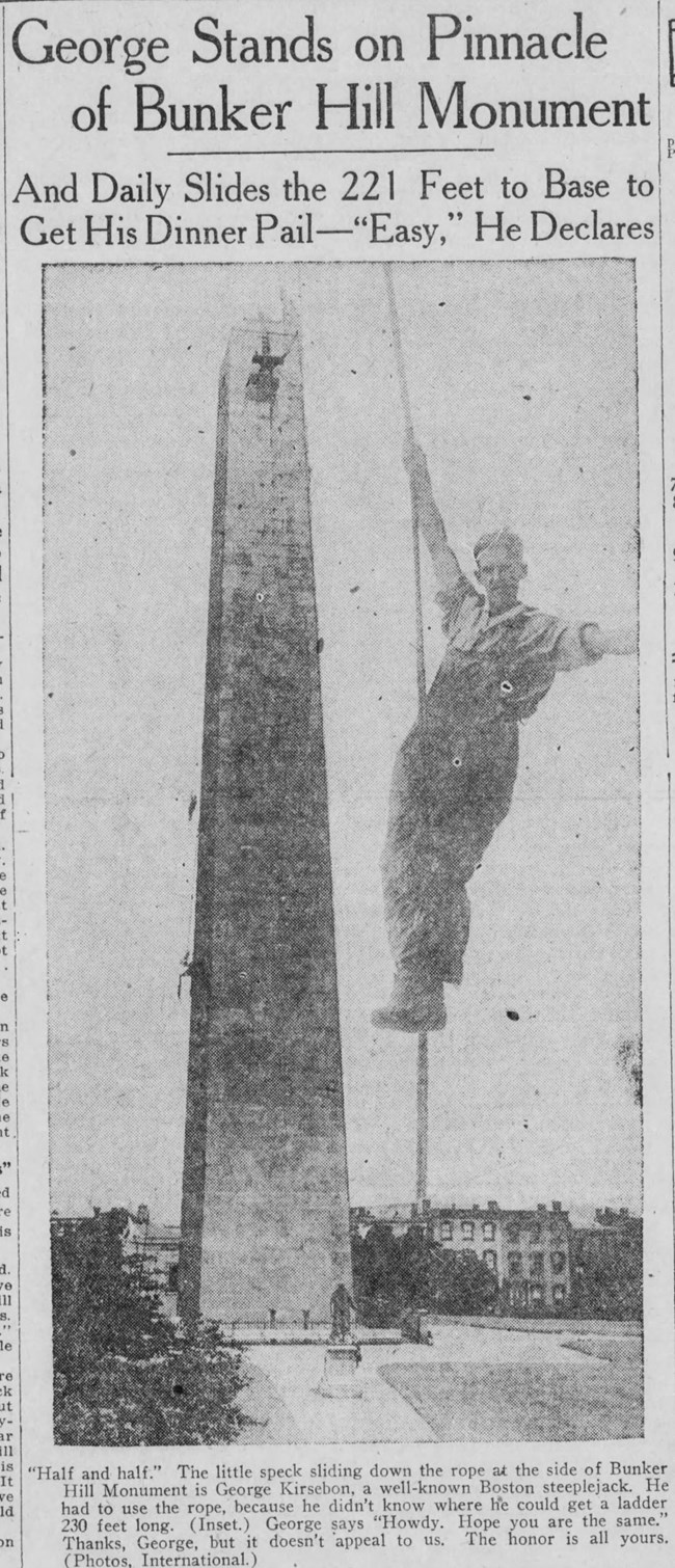 A worker hanging from a rope beside the monument, 1920