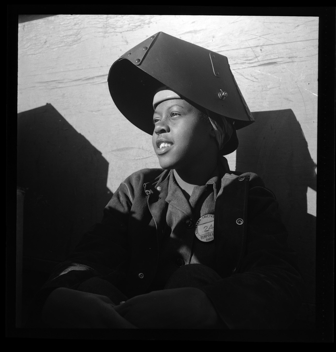 Portrait of a young African American woman in a welder's helmet