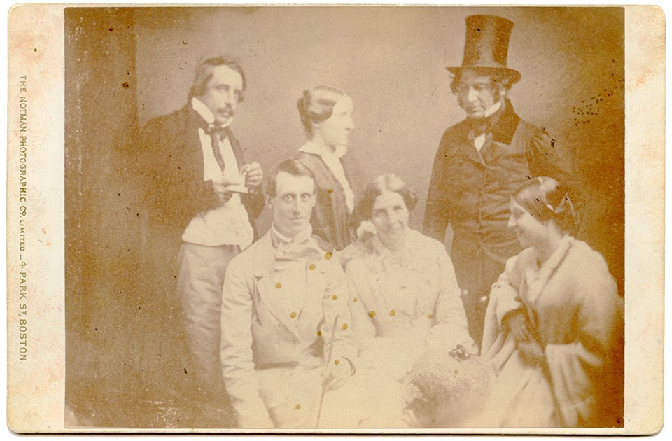 Black and white group photograph of three men and three women in a studio