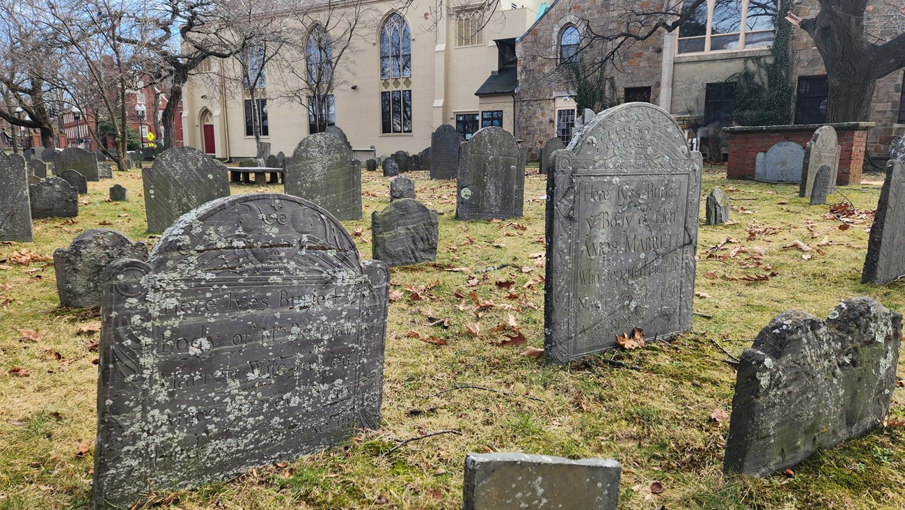 Two stone headstones in a burying ground with partially legible inscriptions for Amos Marrett and Bethia Marrett
