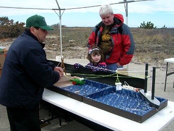 Volunteer showing display to visitors