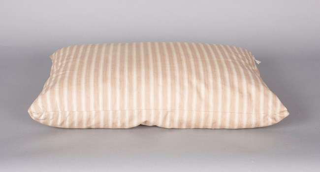Orange-tan and white striped pillow