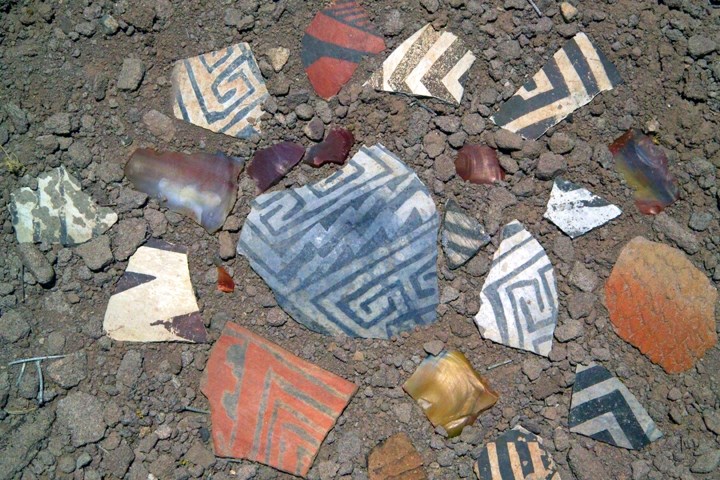 colorful, patterned pottery shards on the ground