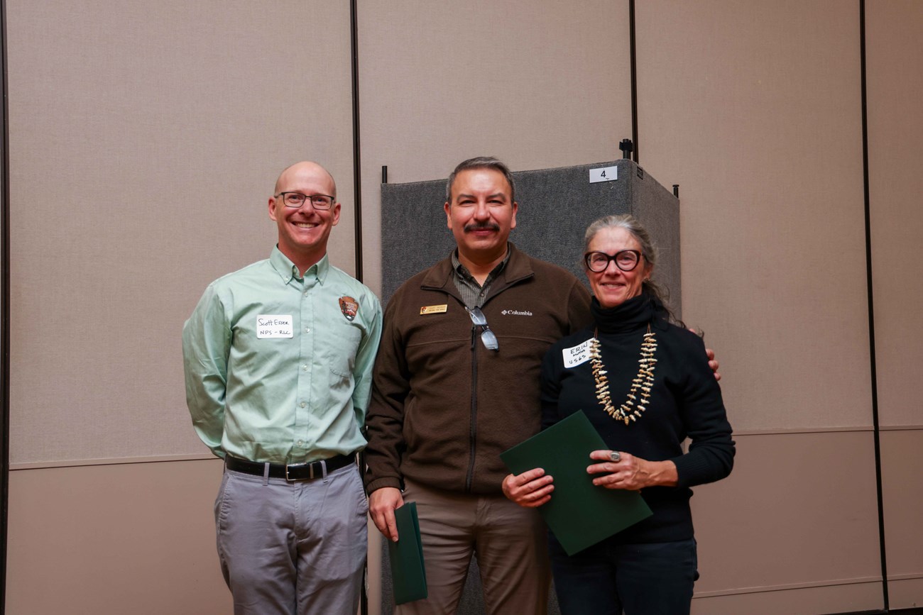Three people standing together during the 2024 Stewardship Award Presentation