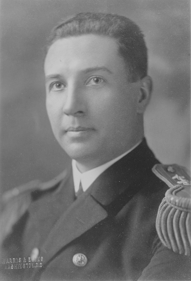 White man wearing a formal naval uniform