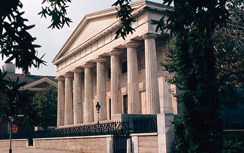 Greek revival style building with eight marble columns.