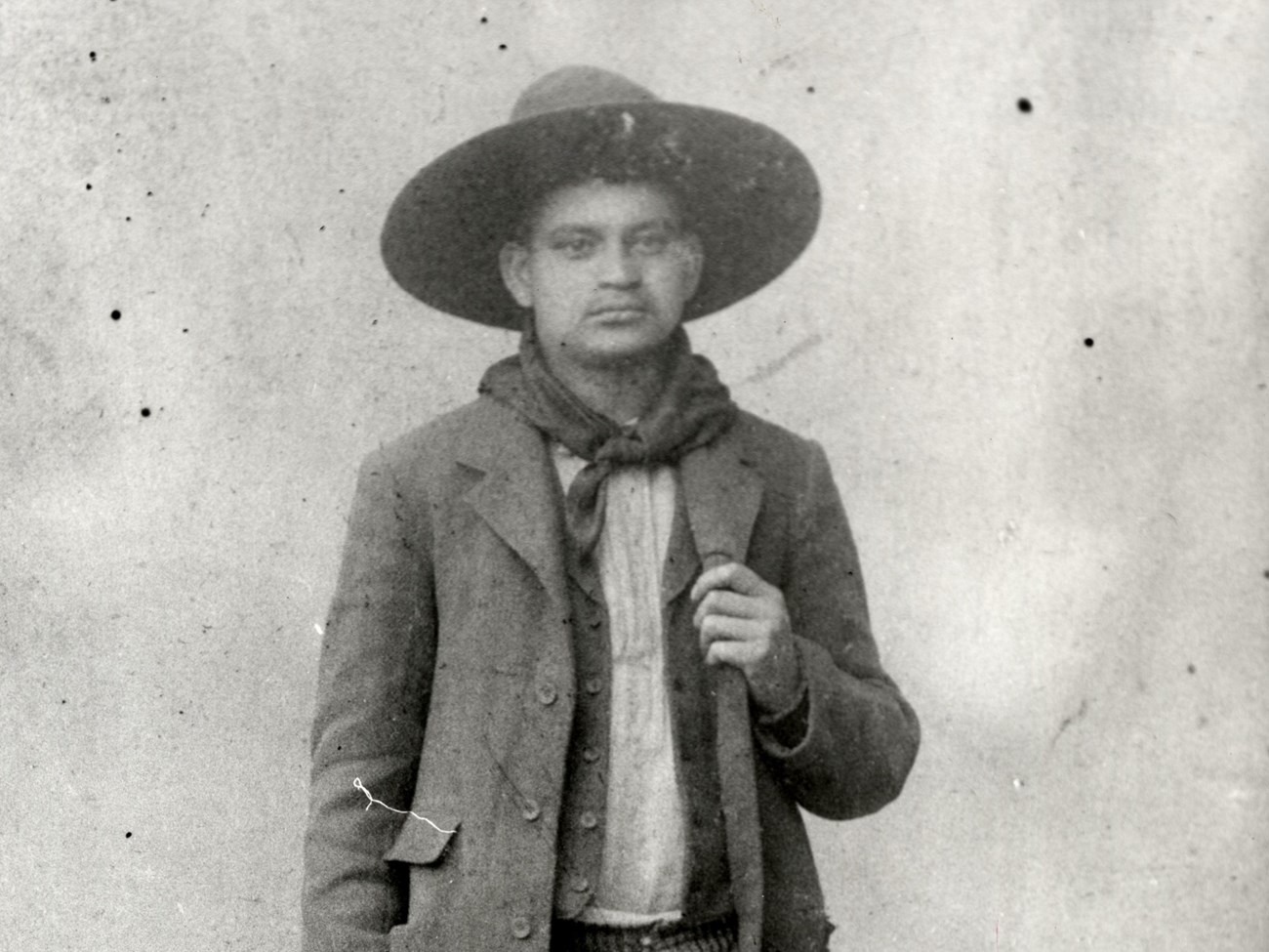 Black and white historic portrait of Crawford Goldsby wearing a wide-brimmed hat