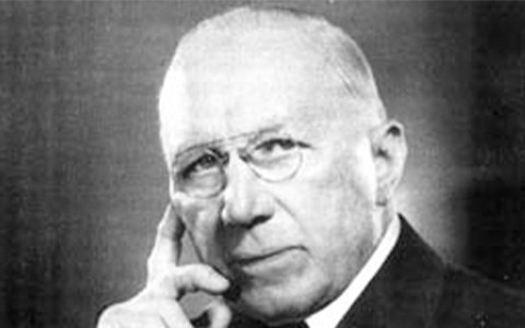Head shot of Judge Lewis facing front with his hand on his chin.